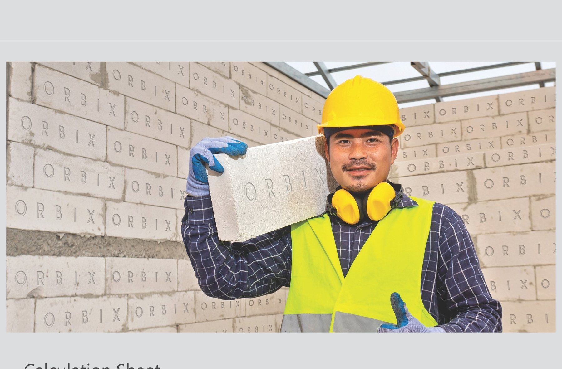 Construction professional handling an Orbix AAC block on site